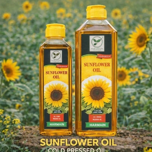Two bottles of Harmain sunflower oil with sunflowers in the background