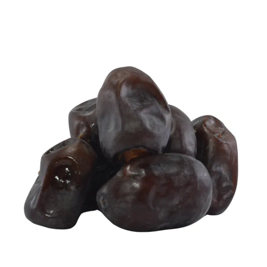 Pile of dark brown dates on a white background