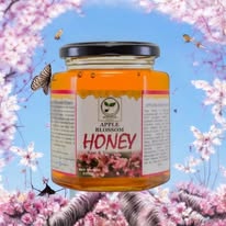 Jar of honey with flowers and butterflies on a blue background