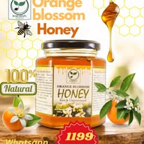 Honey container with orange blossom flavor and a bee illustration on a white background.