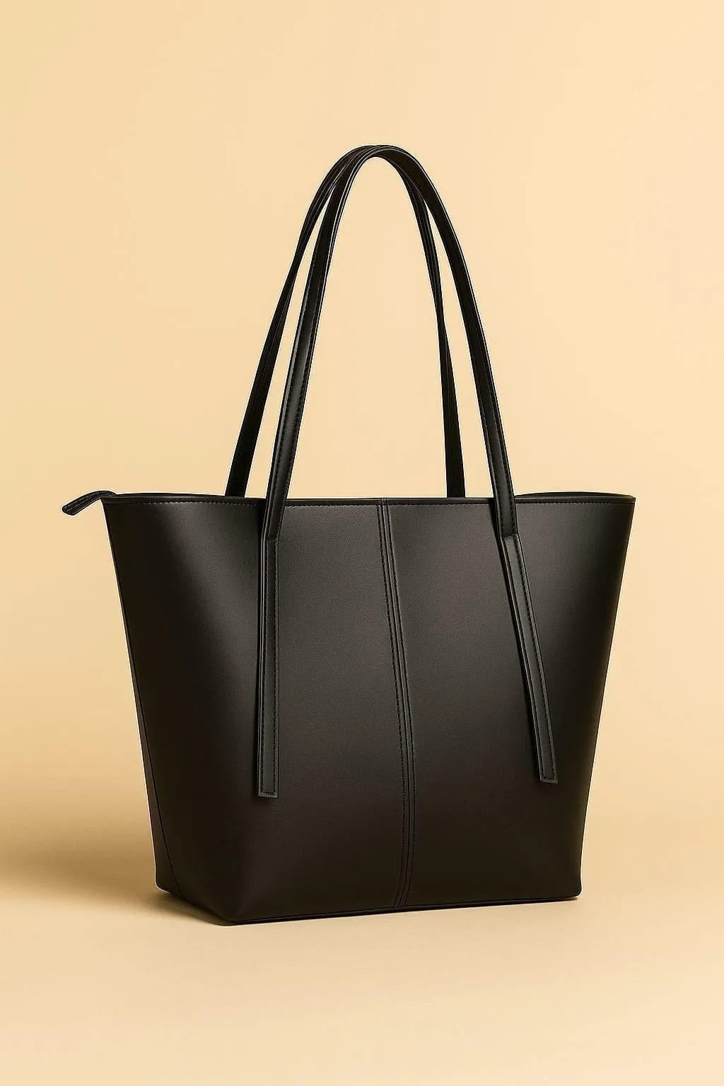 Black tote bag on a beige background