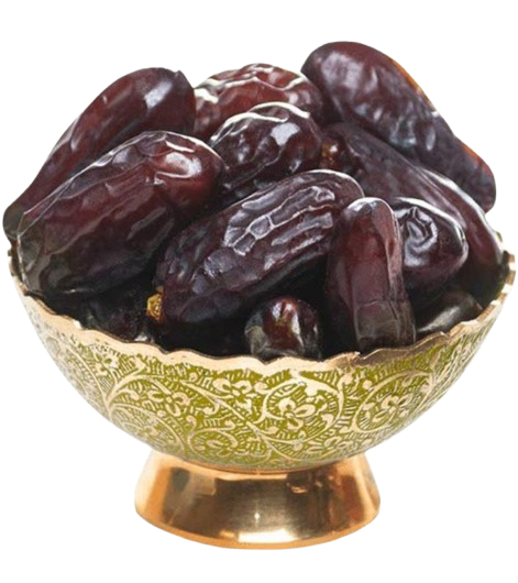 Date fruits in a decorative brass bowl with green patterns on a white background