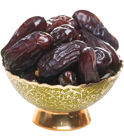Date fruits in a decorative brass bowl with green patterns on a white background