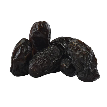 Three dark raisins on a white background