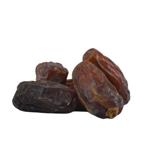 Three dried dates on a white background