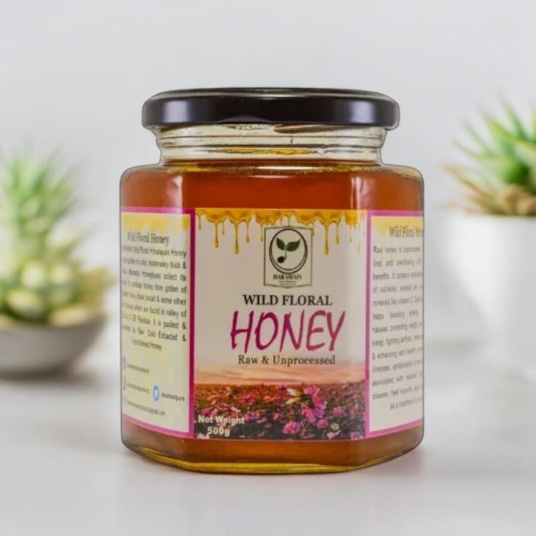 Jar of Wild Floral Honey on a light background with plants