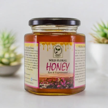 Jar of Wild Floral Honey on a light background with plants