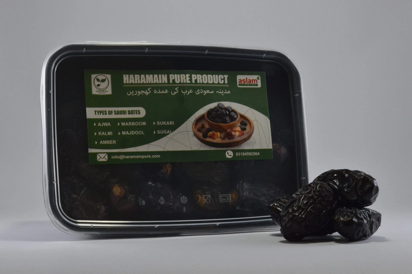 Container of Haramain Pure Product with dates on a gray background