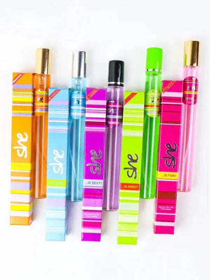 Set of colorful 'she' branded perfume bottles on a white background