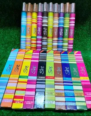 Set of colorful pens with 'She' branding on a green background