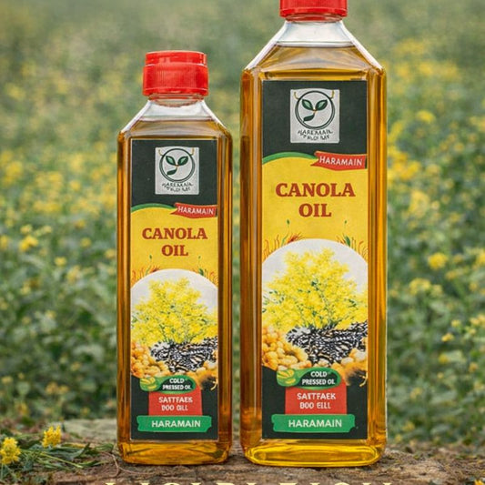 Two bottles of Canola oil with a blurred natural background