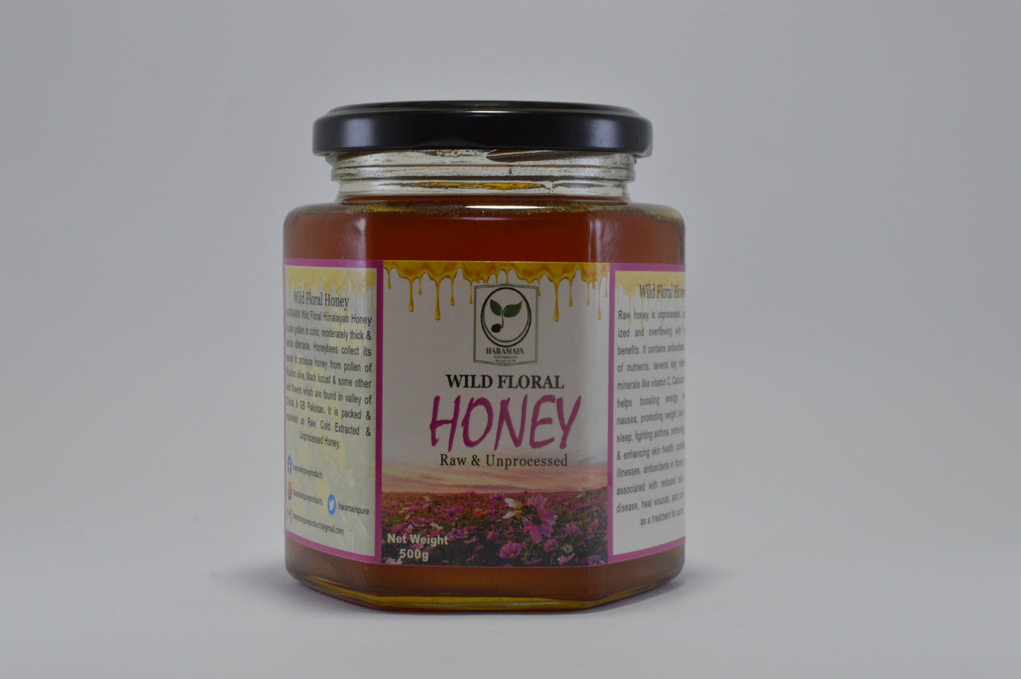 Jar of wild floral honey with a label on a gray background