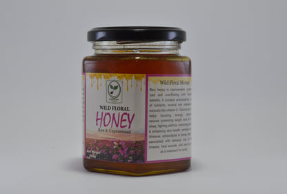 Jar of wild floral honey with a label on a gray background