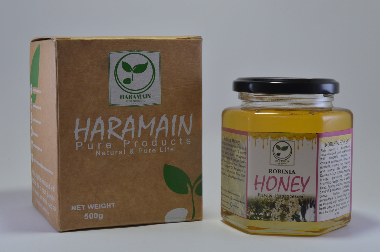 Jar of honey and box of Haramain Pure Products on a white background