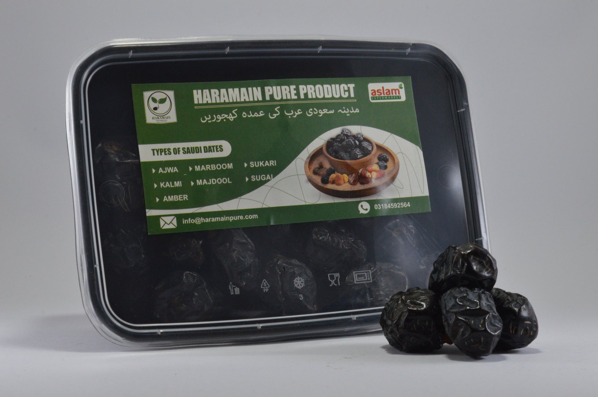 Container of Haramain Pure Product with saudi dates on a gray background