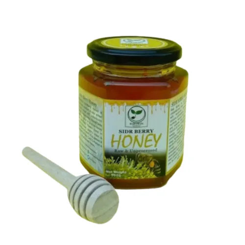 Jar of Sidr Berry Honey with a honey dipper on a white background